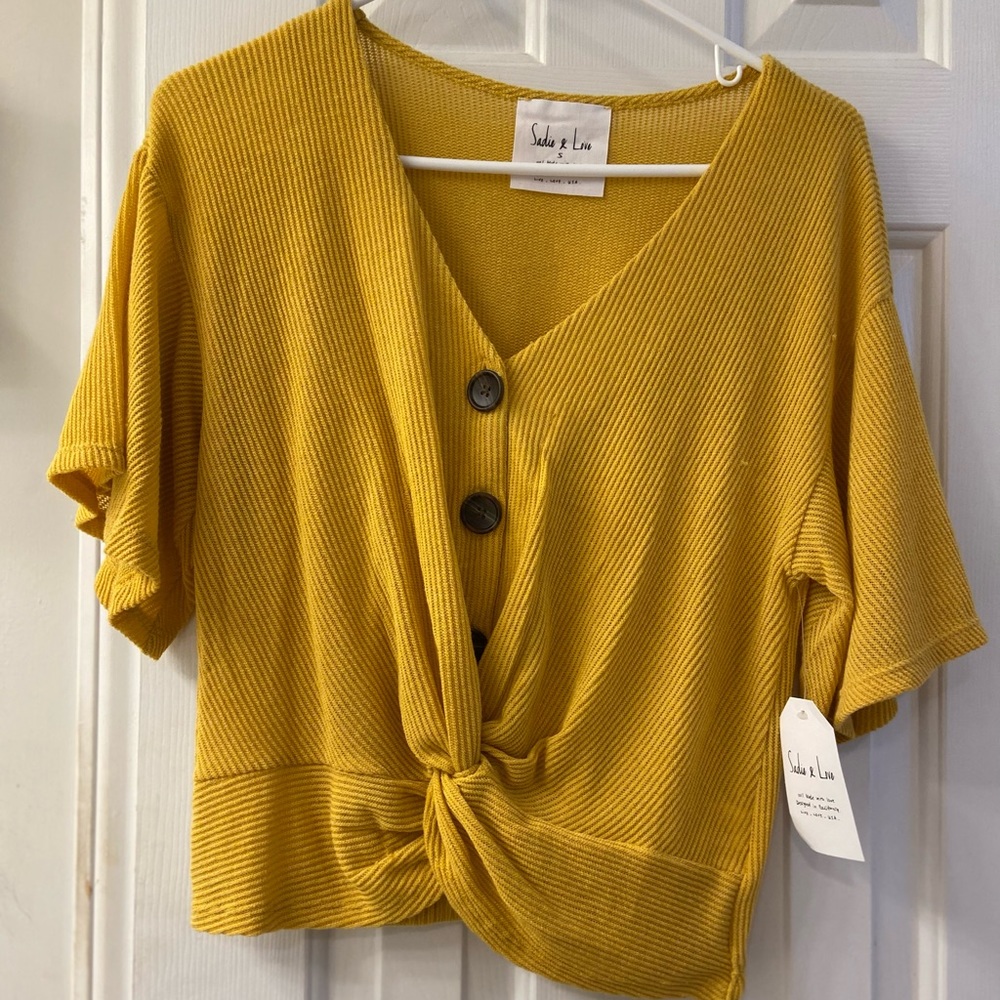 Yellow top with button detail.